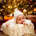 "Baby in a basket, under a Christmas tree, during the holiday season.More of the baby and family Here -"