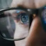Close-up Portrait of Software Engineer Working on Computer, Line of Code Reflecting in Glasses. Developer Working on Innovative e-Commerce Application using Machine Learning, AI Algorithm, Big Data