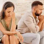 Fight, divorce and depression with couple on sofa for conflict, therapy and mental health or marriage counseling. Sad, anxiety and stress with man and woman in living room for fail, crisis and angry