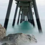 Image of the sea under a bridge, silky water in an unreal image.