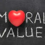 moral values phrase handwritten on blackboard with heart symbol instead O