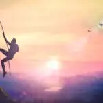 Silhouette bold heroic man try to climb with rope over natural rocky wall wide valley autumn sunset mountain background