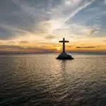Sunset background on large cross of Sunken Cemetery in Camiguin Island. Philippines.