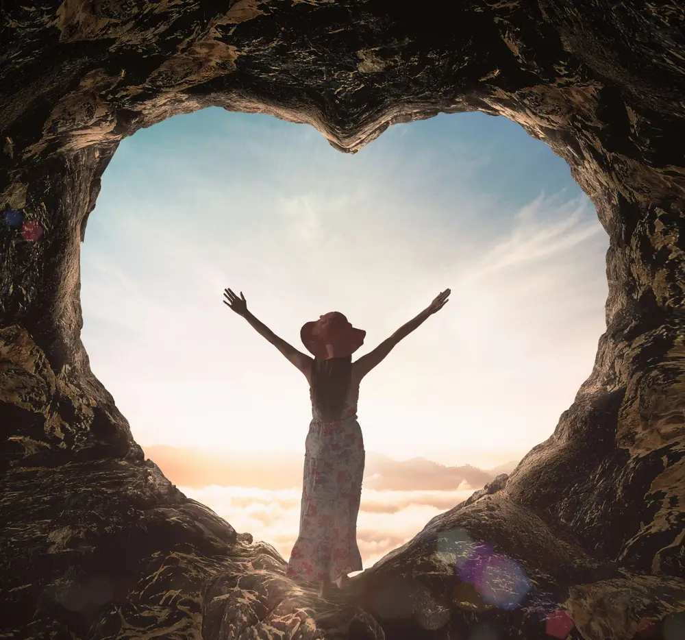 International human rights day concept: Silhouette alone woman standing on cave of heart and meadow sunset background